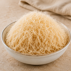 Traditional shredded kataifi pastry in a ceramic bowl with soft natural lighting and artisanal presentation.
